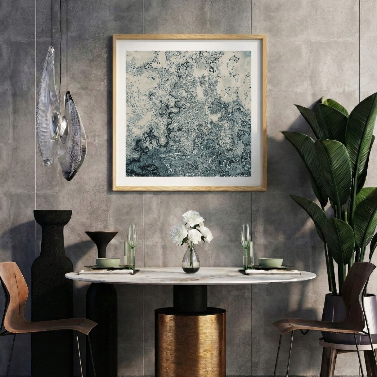 Modern interior with a colorful abstract print on a gray wall, marble table, and decorative items.