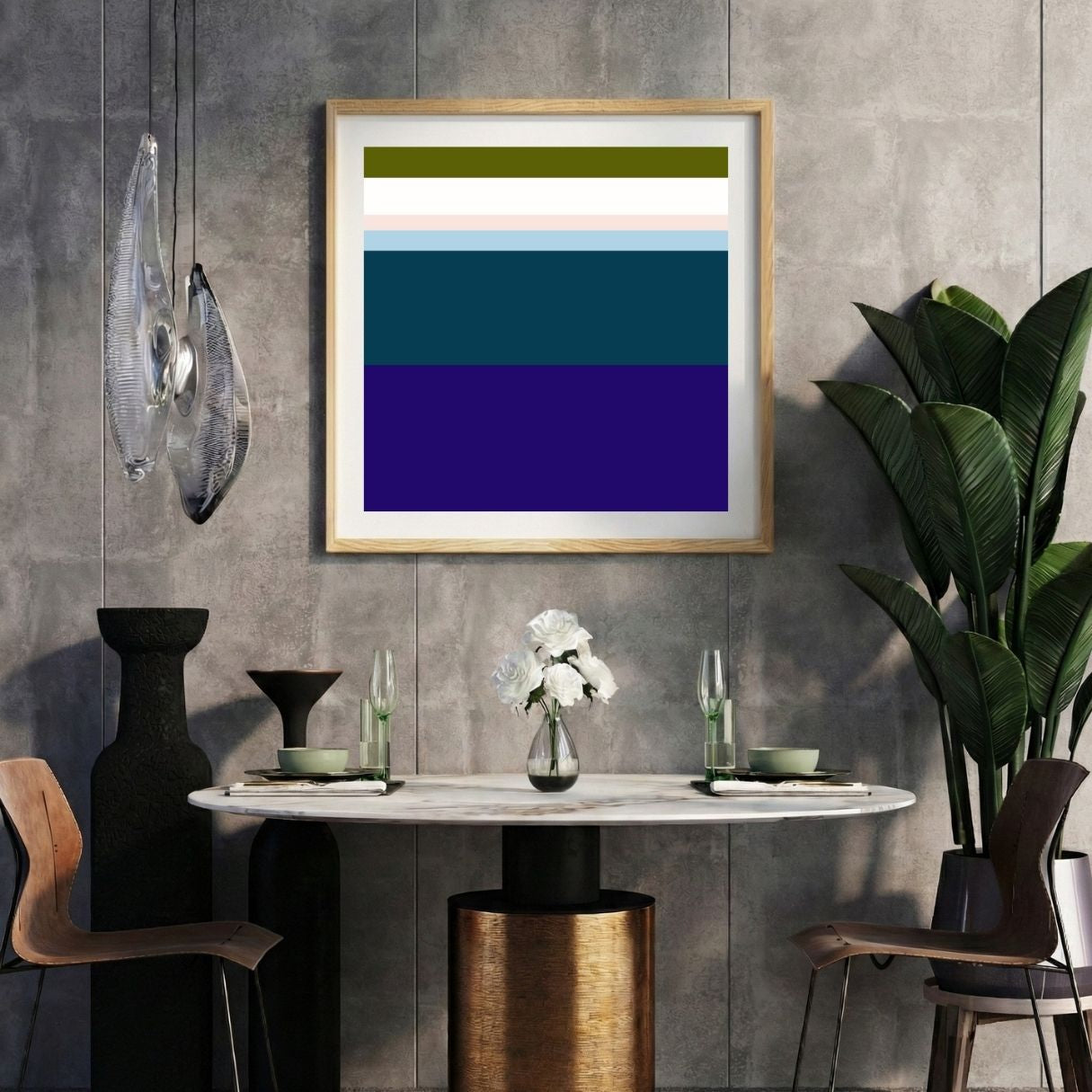 Modern interior with a navy blue striped print on a gray wall, marble table, and decorative items.