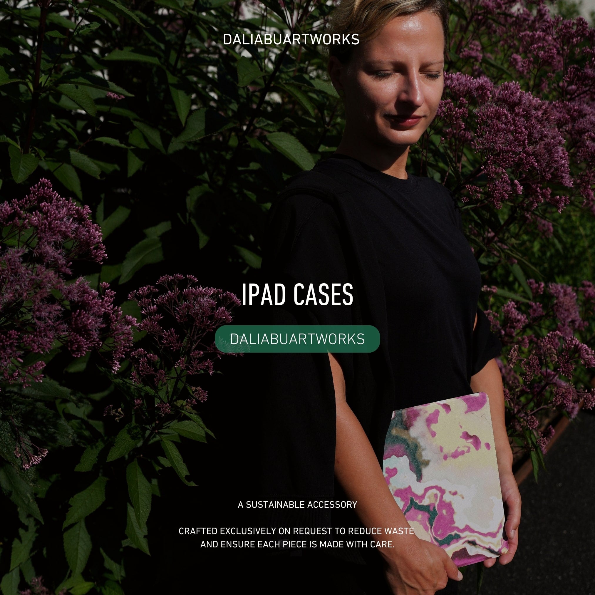 Person holding a colorful iPad case with 'Dalia Buartworks' branding against a natural background.