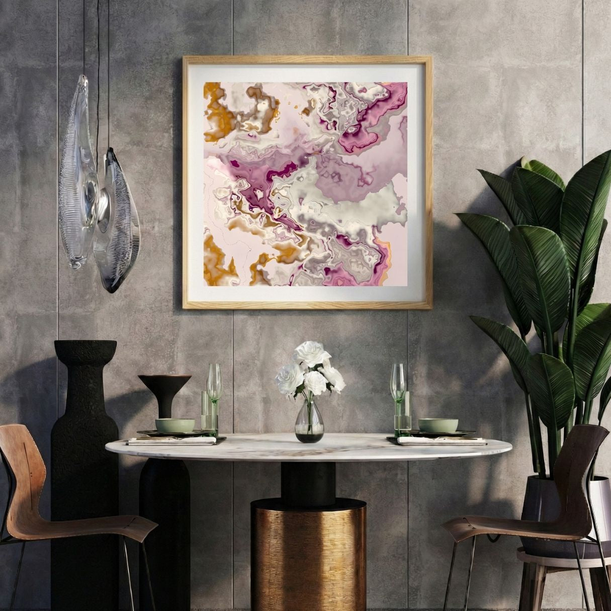 Modern interior with a marbled pink abstract print on a gray wall, marble table, and decorative items.