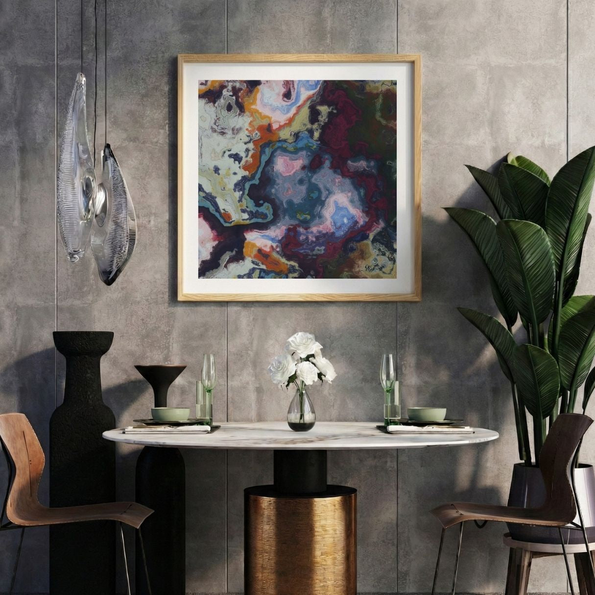 Modern interior with a colorful abstract print on a gray wall, marble table, and decorative items.