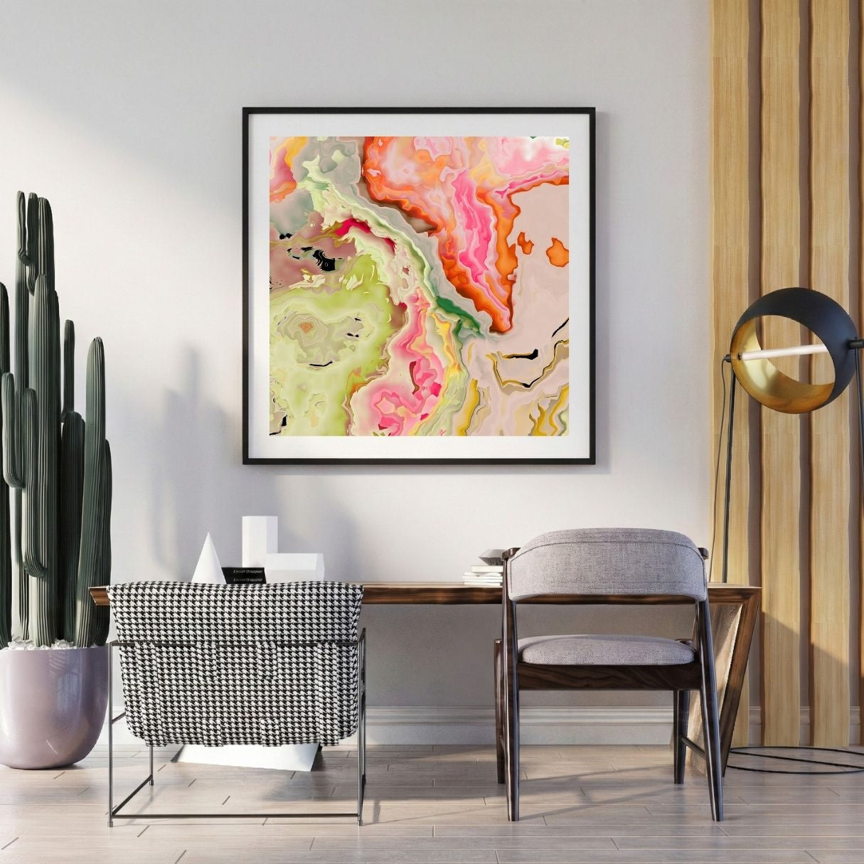 Modern interior with a colorful neon pink abstract print on the wall, a desk, and decorative items.
