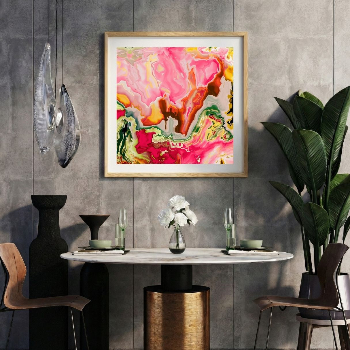 Modern interior with a neon pink abstract print on a gray wall, marble table, and decorative items.