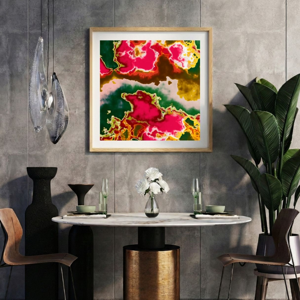 Modern interior with a neon pink abstract print on a gray wall, marble table, and decorative items.