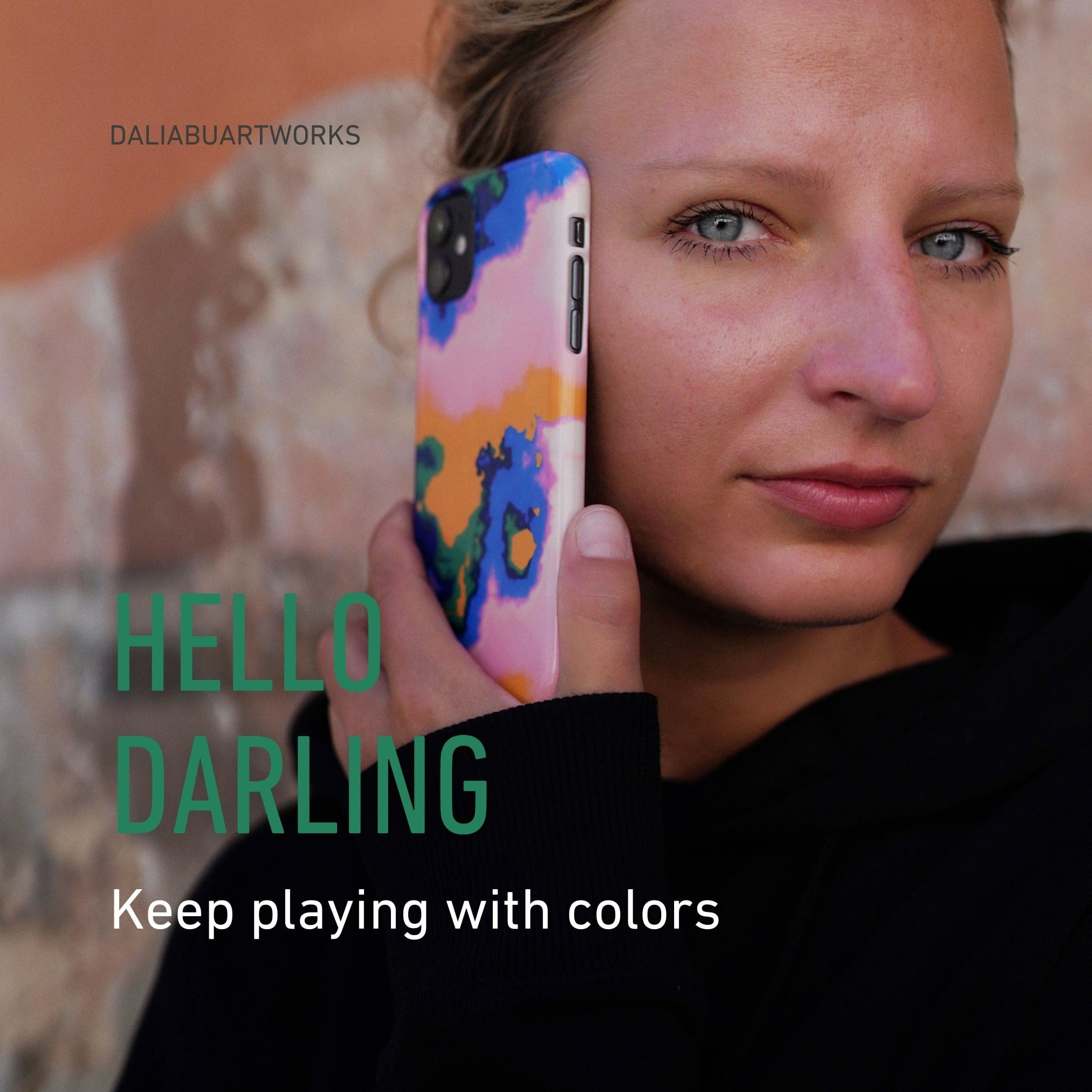 Woman holding a phone with a colorful case, text overlay 'HELLO DARLING Keep playing with colors' by DALIABUARTWORKS