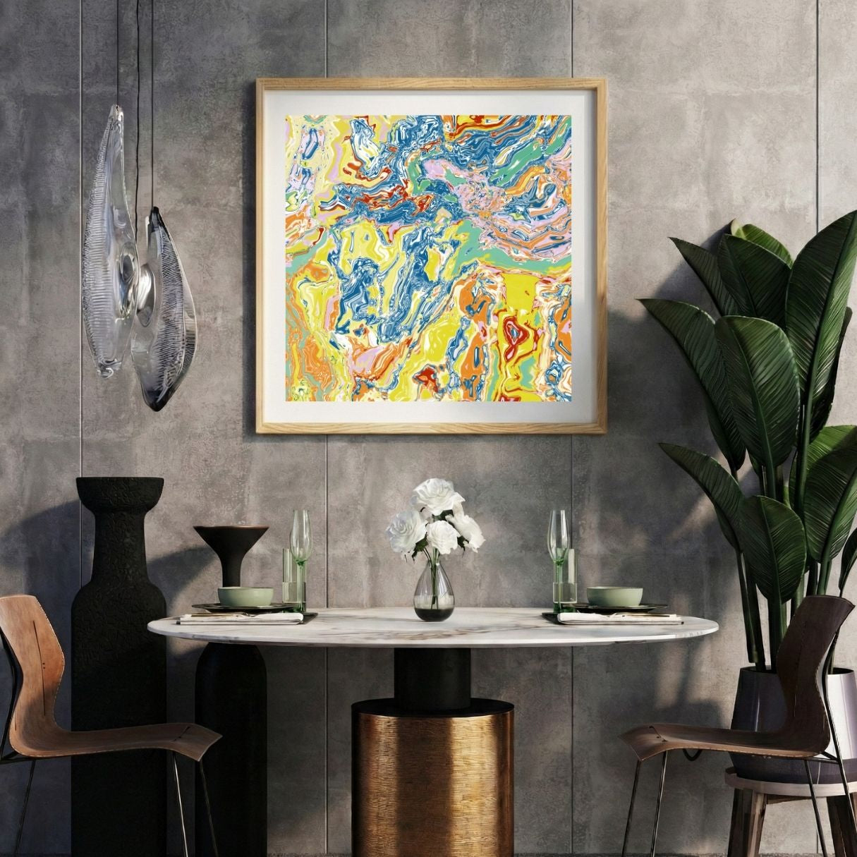 Modern interior with a yellow abstract print on a gray wall, marble table, and decorative items.