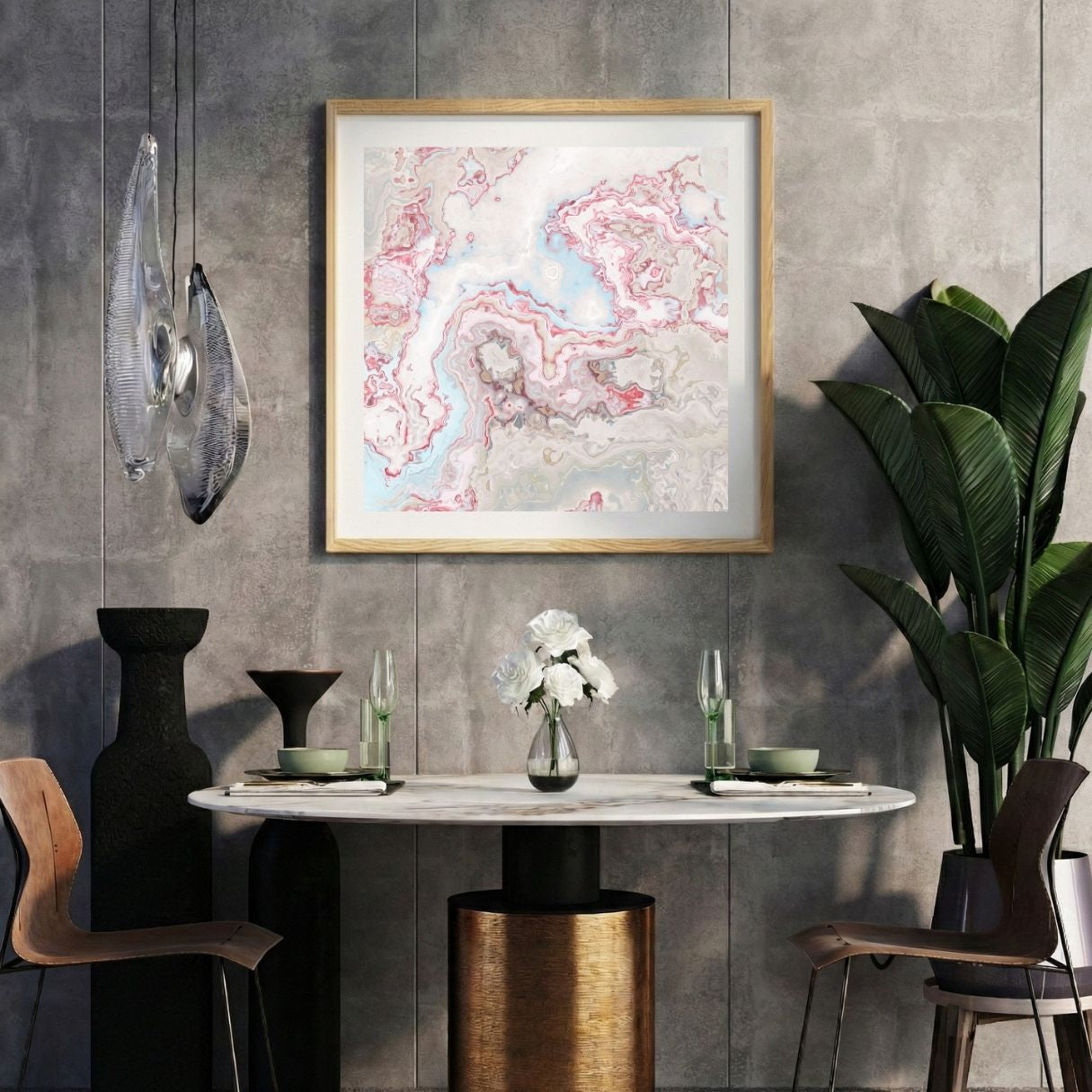 Modern interior with a light abstract print on a gray wall, marble table, and decorative items.