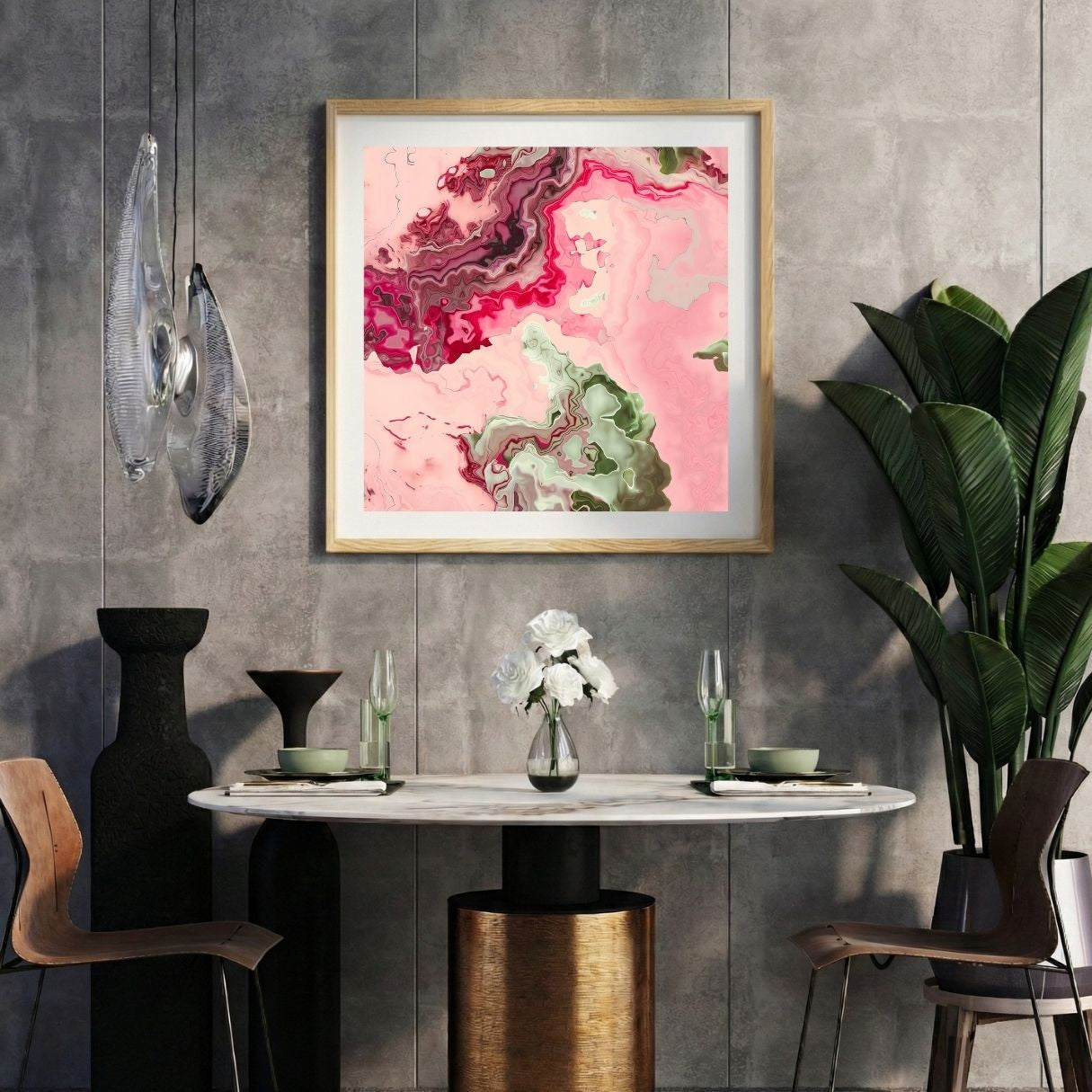 Modern interior with a pink abstract print on a gray wall, marble table, and decorative items.