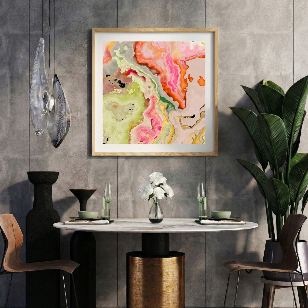 Modern interior with a neon pink abstract print on a gray wall, marble table, and decorative items.