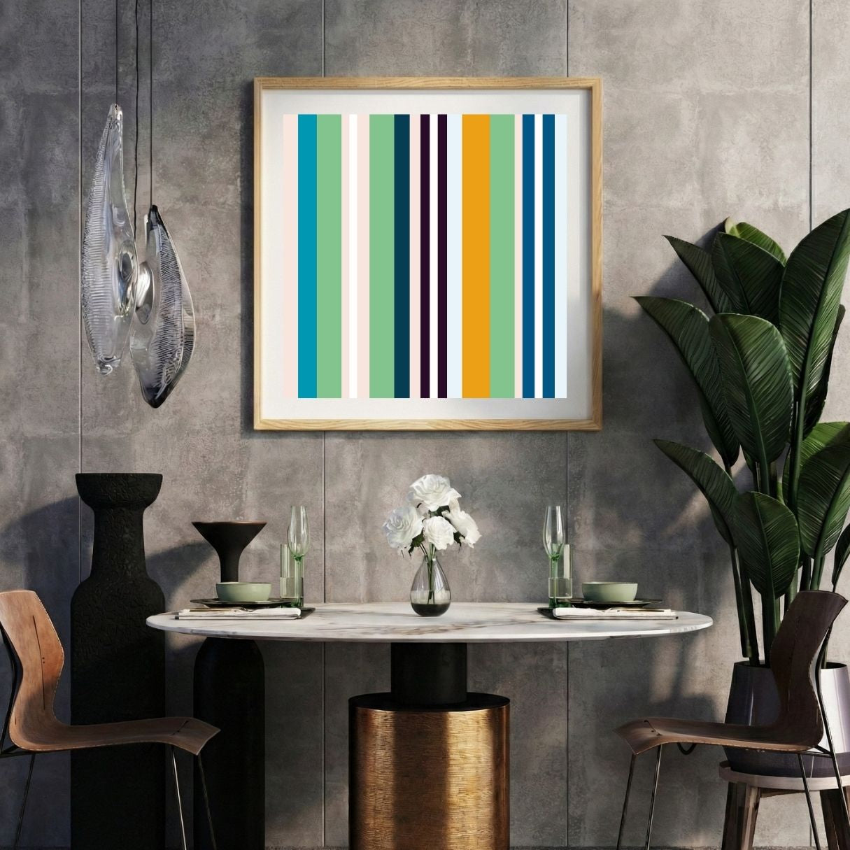 Modern interior with a mint striped print on a gray wall, marble table, and decorative items.