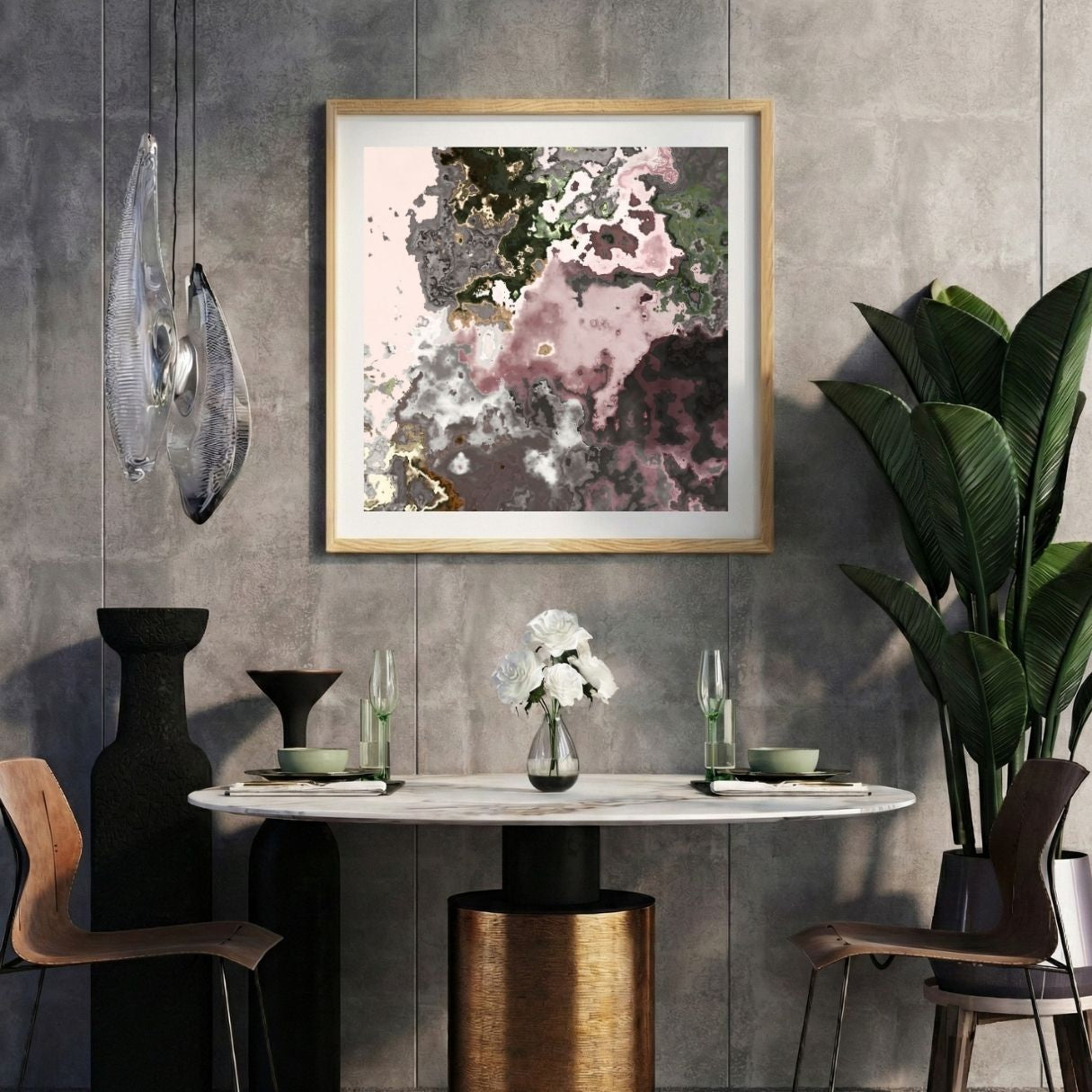 Modern interior with a marbled pink abstract print on a gray wall, marble table, and decorative items.