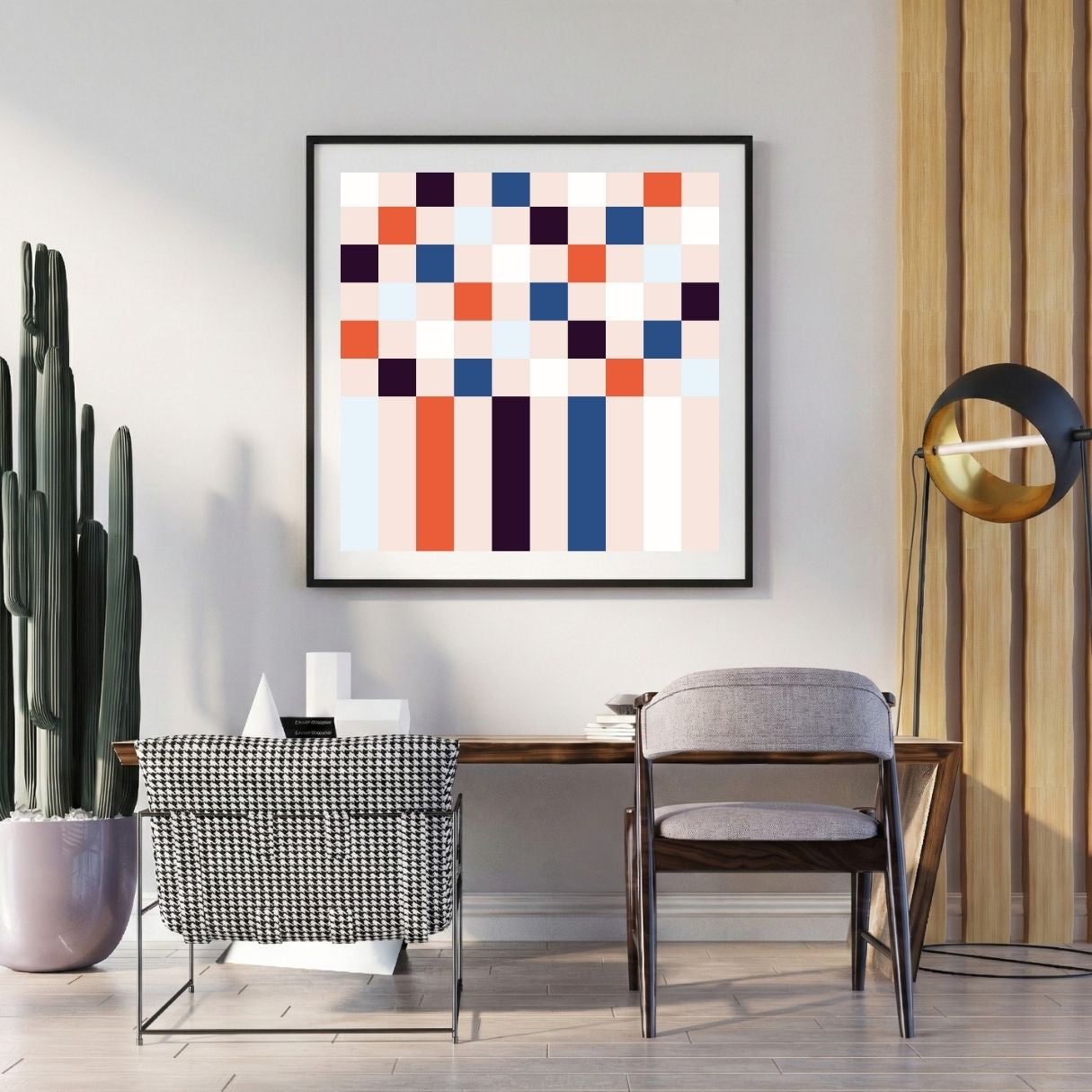Modern interior with a geometric abstract art piece on the wall, a desk, and decorative items.