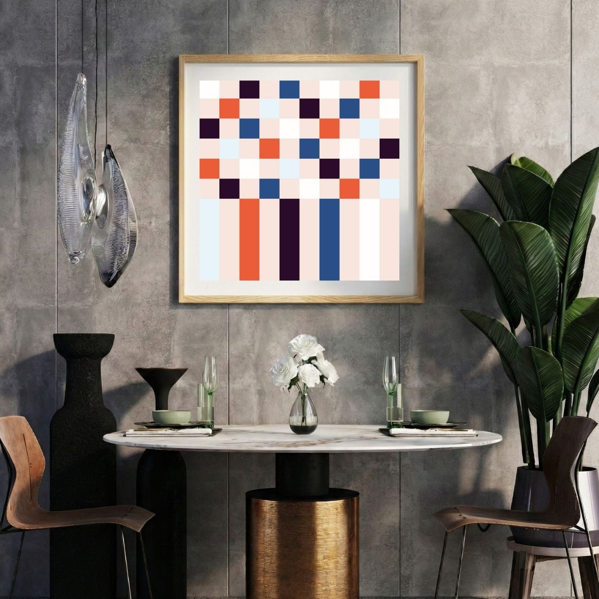 Modern interior with a pink and blue geometric pixel print on a gray wall, marble table, and decorative items.