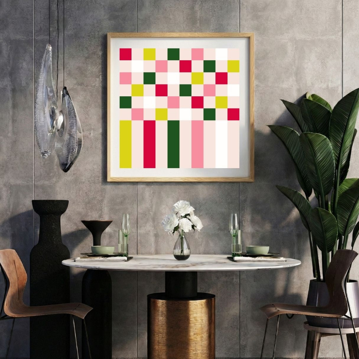 Modern interior with a pink geometric pixel print on a gray wall, marble table, and decorative items.
