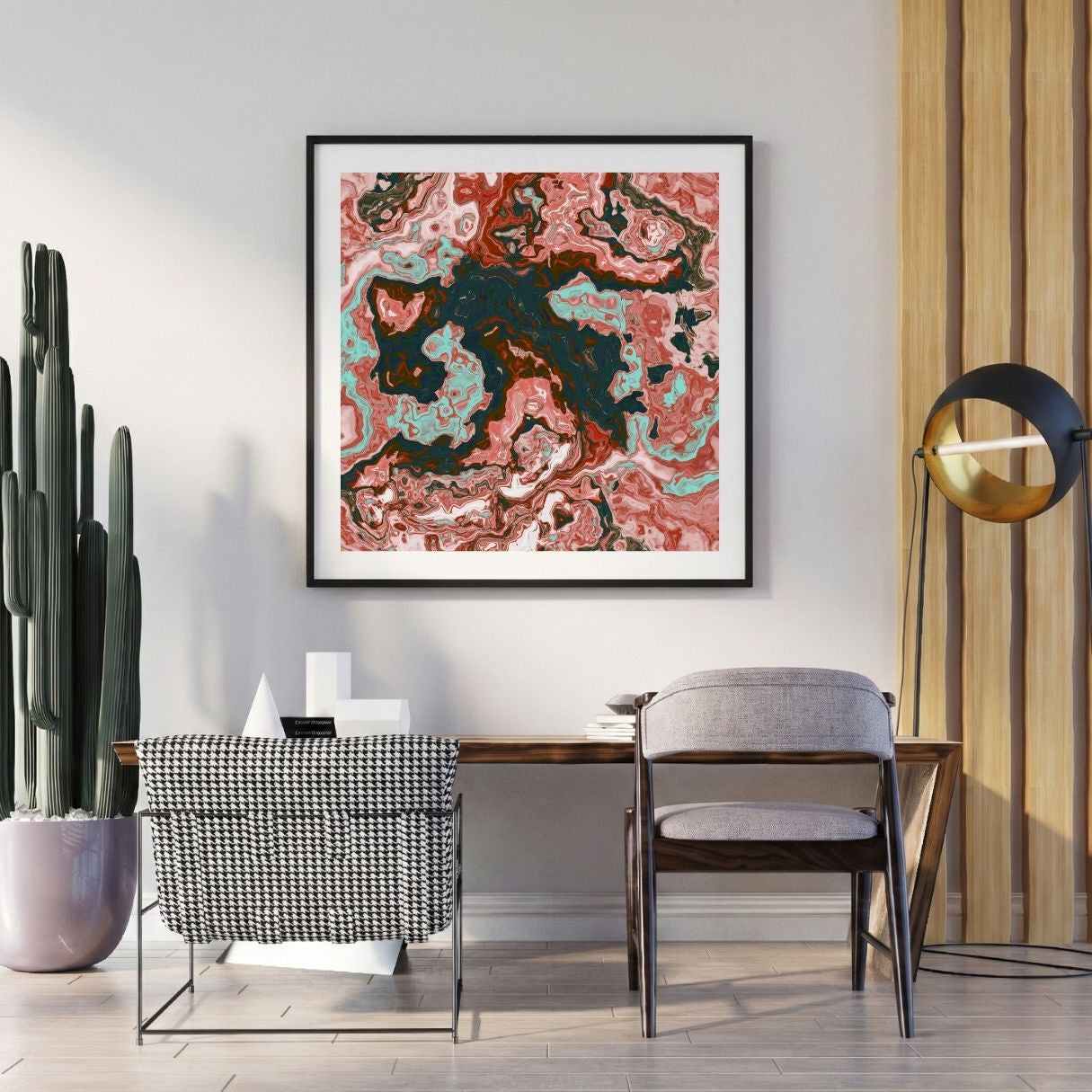 Modern interior with a red abstract print, a desk, and decorative items.